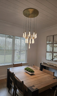 Dining room with modern chandelier over table
